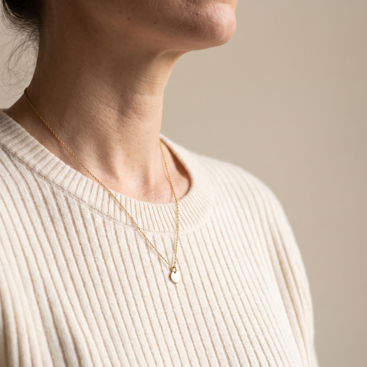 Fine gold pendant necklace worn